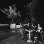 "Couple eating at an outdoor table."